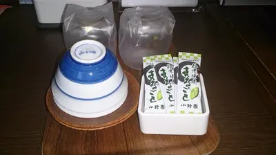 a vase sitting on a wooden table next to a container at Asakusa Central Hotel in Tokyo