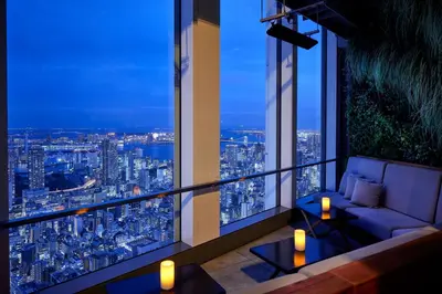 a room with a view of a city at night at Andaz Tokyo - A Concept by Hyatt in Tokyo
