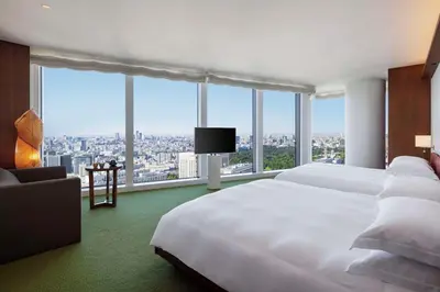 a bedroom with a large white bed and a large window at Andaz Tokyo - A Concept by Hyatt in Tokyo