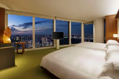 a bedroom with a large white bed and a large window at Andaz Tokyo - A Concept by Hyatt in Tokyo