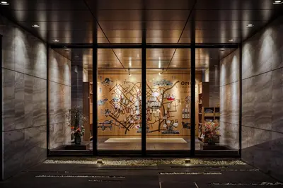 an entrance to a building with a mural on the wall at OMO3 Tokyo Akasaka by Hoshino Resort in Tokyo