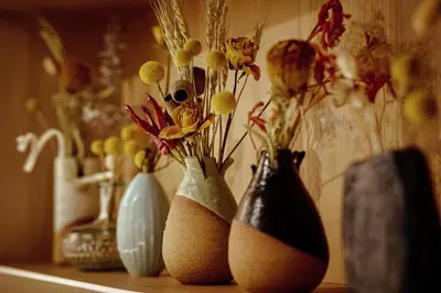 a row of vases with flowers in them on a shelf at OMO3 Tokyo Akasaka by Hoshino Resort in Tokyo