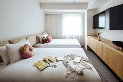 a hotel room with two beds and a flat screen tv at OMO3 Tokyo Akasaka by Hoshino Resort in Tokyo