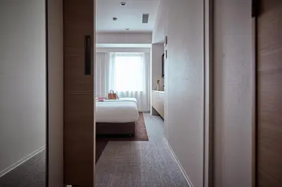 a hotel room with a bed and a window at OMO3 Tokyo Akasaka by Hoshino Resort in Tokyo