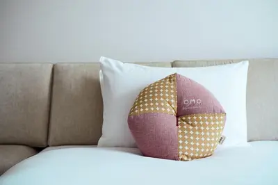 a pillow sitting on top of a bed at OMO3 Tokyo Akasaka by Hoshino Resort in Tokyo