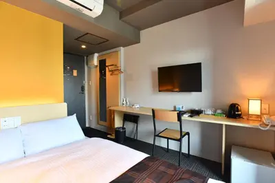 a hotel room with a bed and a desk at FL Hotel Asakusa in Tokyo