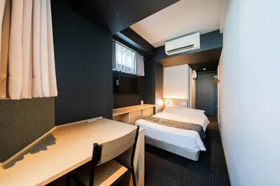 a small room with a bed and a desk at FL Hotel Asakusa in Tokyo