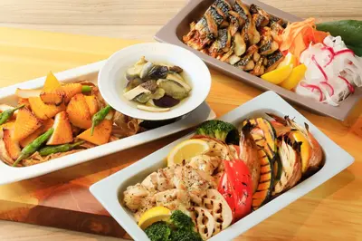 a table with four dishes of different types of food at Via Inn Shinagawa Oimachi in Tokyo