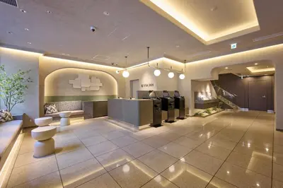 a large lobby with a hair salon at Via Inn Shinjuku in Tokyo