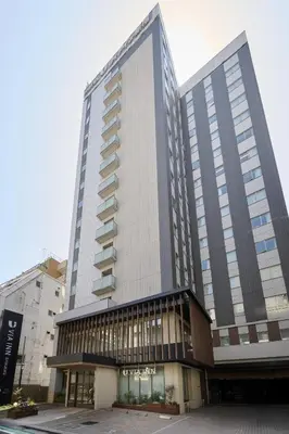 a large tall building with a lot of windows at Via Inn Shinjuku in Tokyo