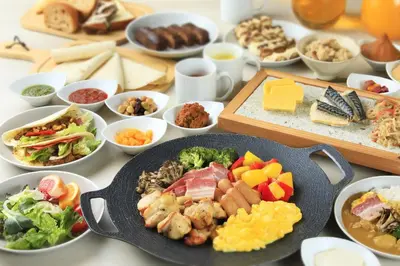a table with a bunch of different types of food at Via Inn Shinjuku in Tokyo