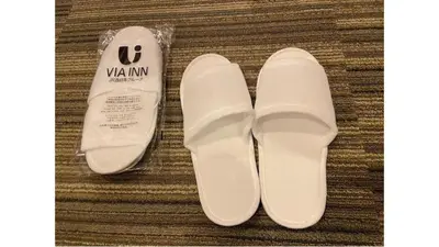 a pair of white socks next to a tube of sock at Via Inn Higashi-Ginza in Tokyo