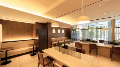 a restaurant with tables and chairs and a large window at Via Inn Higashi-Ginza in Tokyo