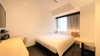 a hotel room with a bed and a table at Via Inn Iidabashi Korakuen in Tokyo