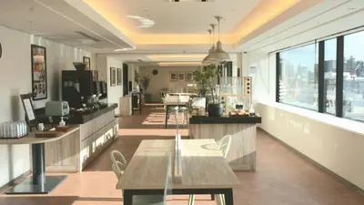 a restaurant with a table and chairs in a room at Via Inn Iidabashi Korakuen in Tokyo