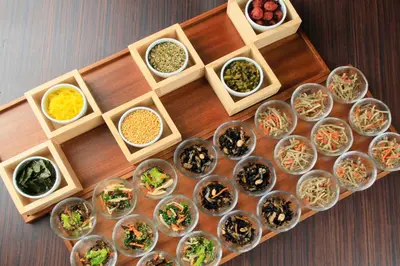 a table topped with bowls of different types of food at Via Inn Akihabara in Tokyo