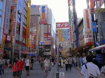 a crowd of people walking down a busy city street at ENT TERRACE Asakusa in Tokyo
