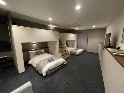 a hotel room with two beds and a television at ENT TERRACE Asakusa in Tokyo