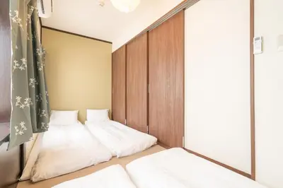 a bedroom with two beds and a window at Otsuka house with 2BR near the Yamanote line in Tokyo