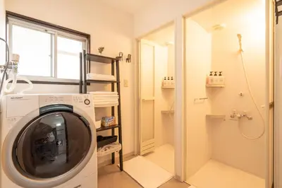 a washing machine in a bathroom with a shower at Otsuka house with 2BR near the Yamanote line in Tokyo