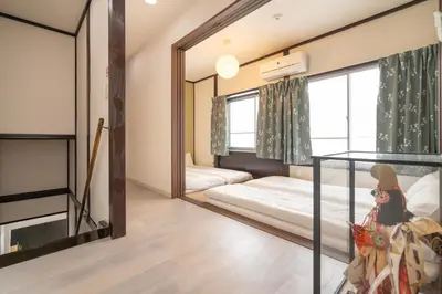 a room with two beds and a mirror at Otsuka house with 2BR near the Yamanote line in Tokyo