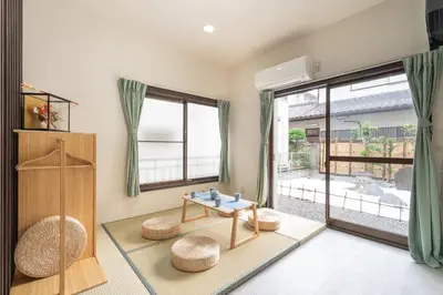 a living room with a table and chairs and a window at Otsuka house with 2BR near the Yamanote line in Tokyo