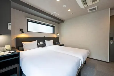 a bedroom with a large white bed and a window at HOTEL TABARD TOKYO - Vacation STAY 64558v in Tokyo