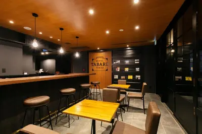 a bar with wooden tables and stools in a restaurant at HOTEL TABARD TOKYO - Vacation STAY 64558v in Tokyo