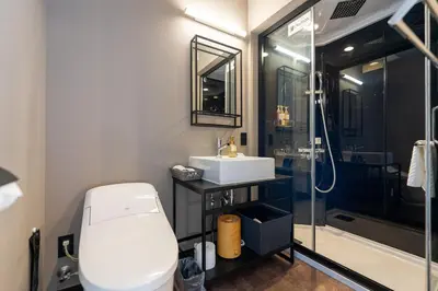 a bathroom with a toilet and a sink and a shower at HOTEL TABARD TOKYO - Vacation STAY 62622v in Tokyo