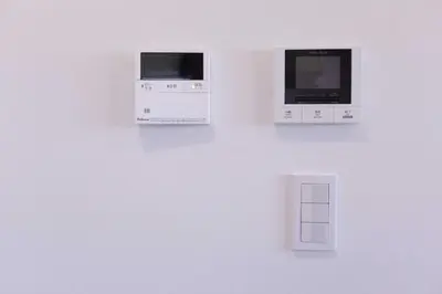 a wall with two microwaves on a wall at japan house sugamo in Tokyo