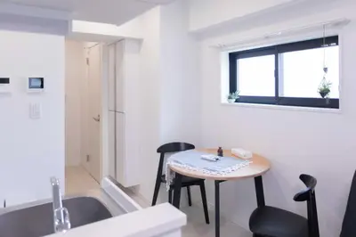 a small kitchen with a table and a sink at japan house sugamo in Tokyo