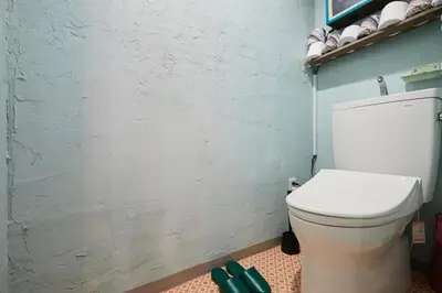 a bathroom with a white toilet and a blue wall at ABURA HAUS - Vacation STAY 13195 in Tokyo