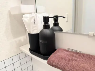 two black bottles sitting on a shelf in a bathroom at Hotel chen's house - Vacation STAY 42508v in Tokyo