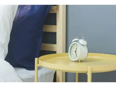 an alarm clock sitting on a table next to a bed at Hotel chen's house - Vacation STAY 42508v in Tokyo