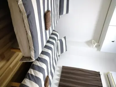 a bed with black and white stripes in a room at Ichijuku Ryokan Kaminarimon - Vacation STAY 75757v in Tokyo