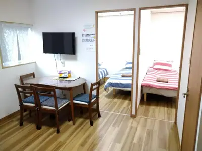 a small room with a table and chairs and a bedroom at Ichijuku Ryokan Kaminarimon - Vacation STAY 75757v in Tokyo