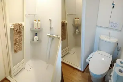 a bathroom with a toilet and a shower stall at Ichijuku Ryokan Kaminarimon - Vacation STAY 75757v in Tokyo