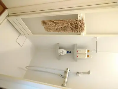 a bathroom with a toilet and a towel rack at Ichijuku Ryokan Kaminarimon - Vacation STAY 75757v in Tokyo