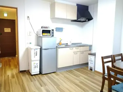 a kitchen with a refrigerator and a microwave at Ichijuku Ryokan Kaminarimon - Vacation STAY 75757v in Tokyo