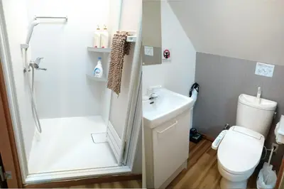 a bathroom with a shower and a toilet and a sink at Ichijuku Ryokan Kaminarimon - Vacation STAY 75757v in Tokyo