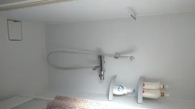 a bathroom with white walls and white fixtures at Ichijuku Ryokan Kaminarimon - Vacation STAY 75796v in Tokyo