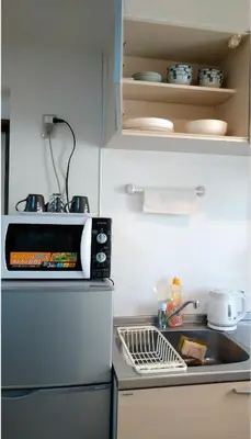 a kitchen with a sink and a microwave at Ichijuku Ryokan Kaminarimon - Vacation STAY 75803v in Tokyo