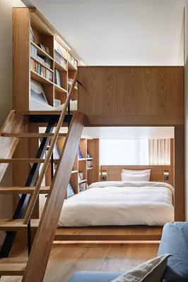 a bedroom with a bunk bed with wooden shelves at MUJI HOTEL GINZA in Tokyo