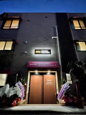 a building with a brown door and a sign above it at SHINJUKU WARM VILLA I in Tokyo