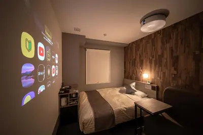 a bedroom with a bed and a wall with stickers at Super Hotel Premier Ikebukuro Natural Hot Spring in Tokyo