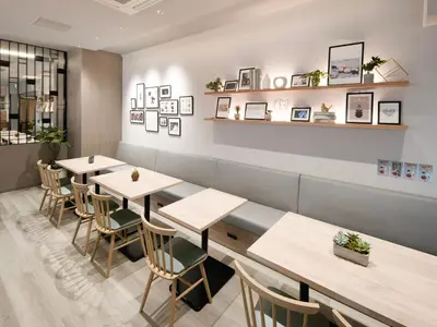 a row of tables in a restaurant with photos on the wall at Super Hotel Premier Ikebukuro Natural Hot Spring in Tokyo