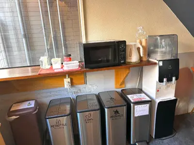 a group of trash cans and a microwave on a shelf at STAY WORK ASAKUSA guest house \u6d45\u8349\u5e97 in Tokyo