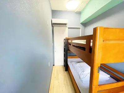 a small room with two bunk beds in it at STAY WORK ASAKUSA guest house \u6d45\u8349\u5e97 in Tokyo