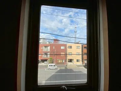 a window with a view of a city street at STAY WORK ASAKUSA guest house \u6d45\u8349\u5e97 in Tokyo