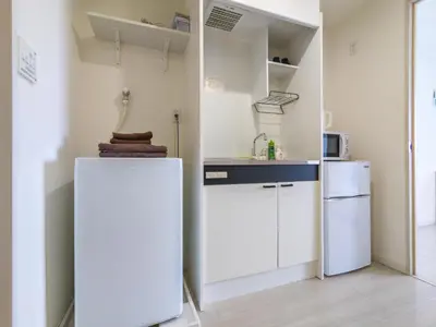 a small kitchen with a refrigerator and a microwave at japan house itabashi in Tokyo